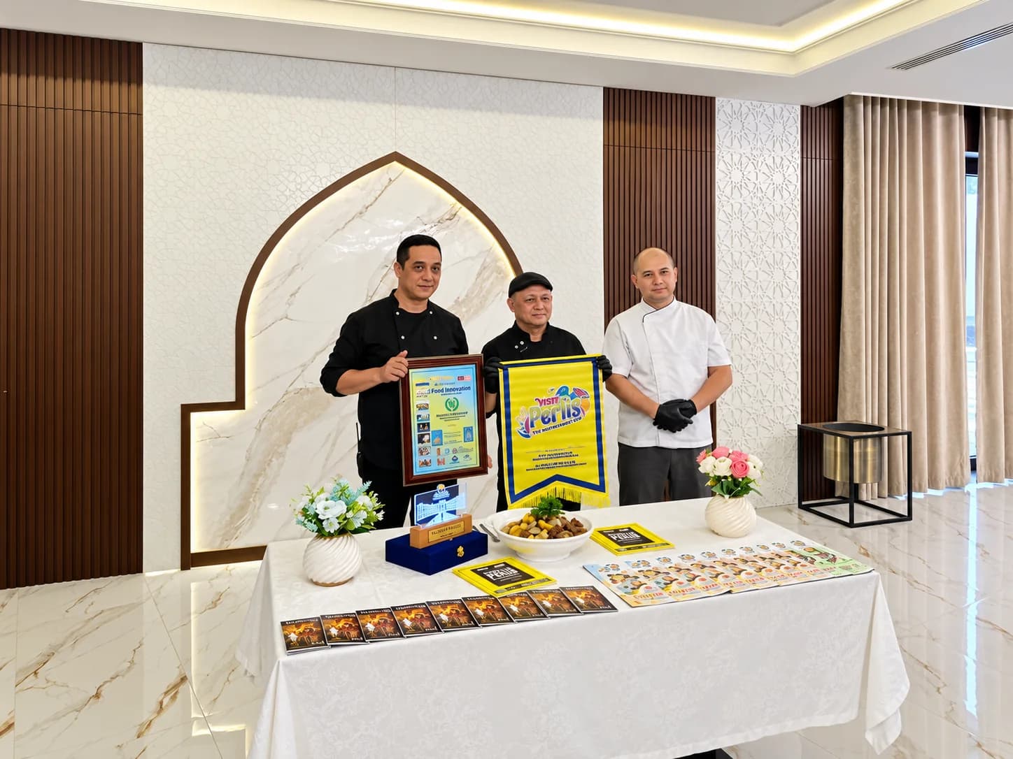 Members of the Perlis delegation presenting a Visit Perlis banner at HADITH Hotel.